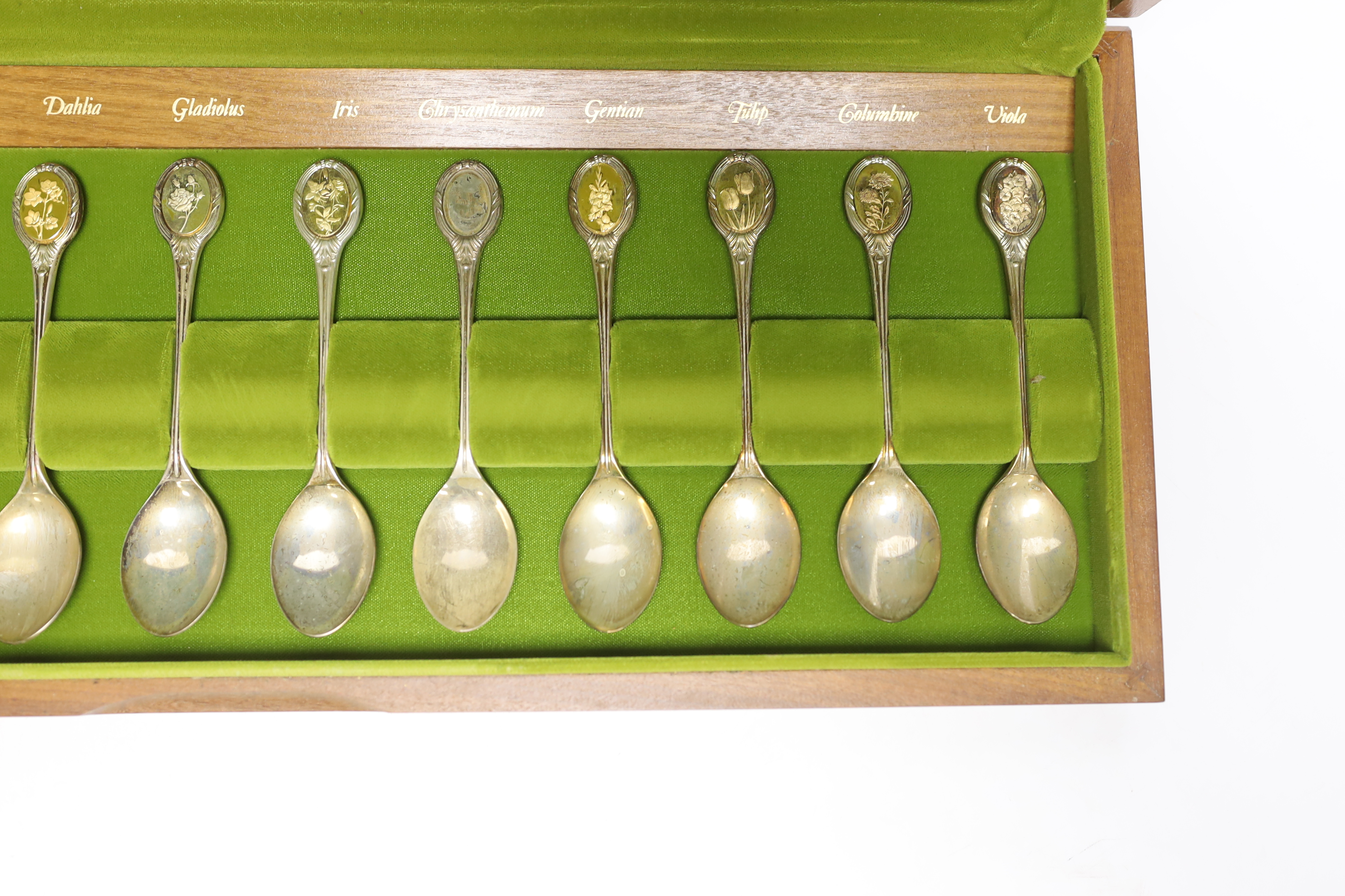 A modern cased set of twelve parcel gilt silver 'Royal Horticultural Society Flower Spoons' by John Pinches, with cert, 9.5oz.
